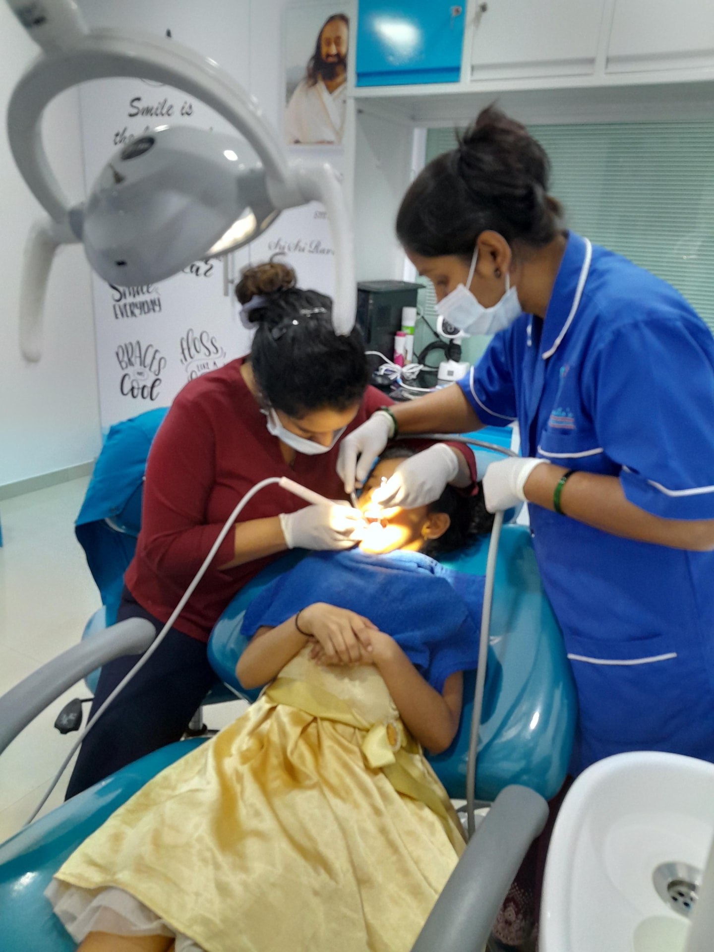 Child dentistry at the clinic: a young patient being treated gently by the dental team